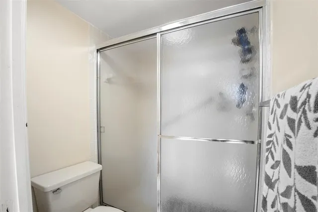 a bathroom with a glass shower door