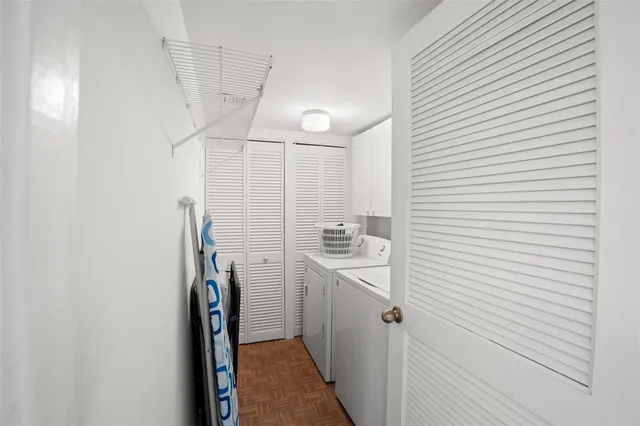 a view of storage and utility room with washer and dryer