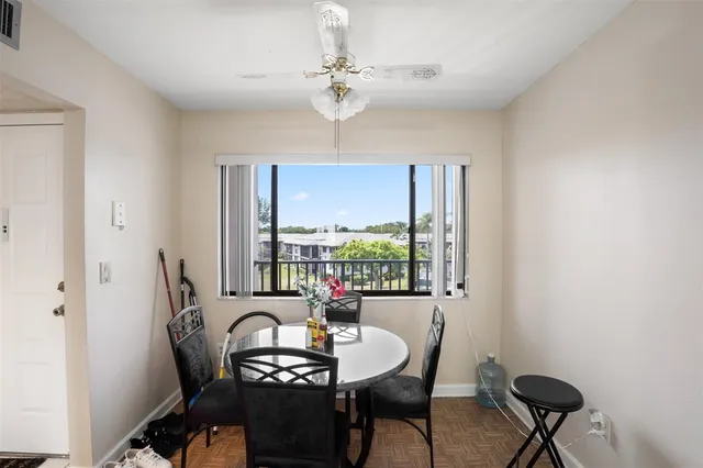 a dining room with furniture a chandelier and window