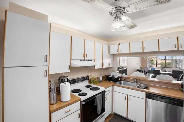 a kitchen with a sink cabinets and window