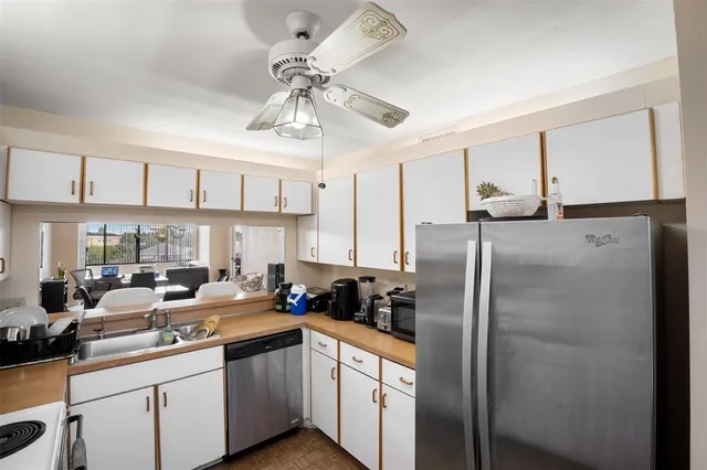 a kitchen with stainless steel appliances a refrigerator sink and cabinets
