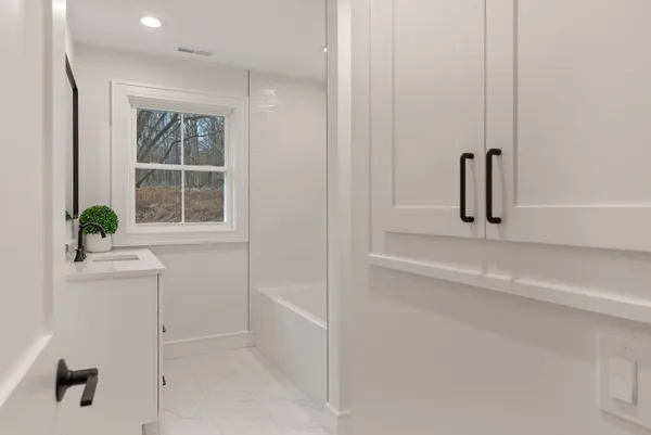 a view of a closet area with mirror