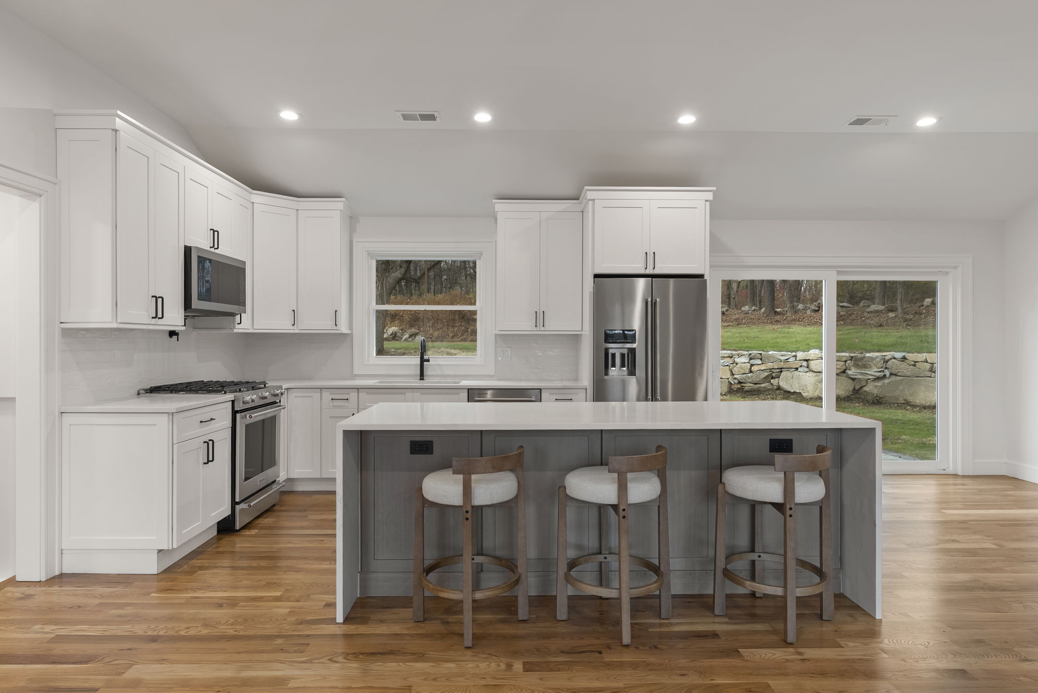 52 Curtis Road Bridgewater, CT 06752 - Photo 2 of 25 a kitchen with stainless steel appliances granite countertop a stove top oven a sink dishwasher and a refrigerator with wooden floor