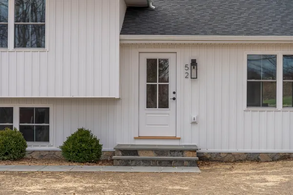 a front view of a house with a yard