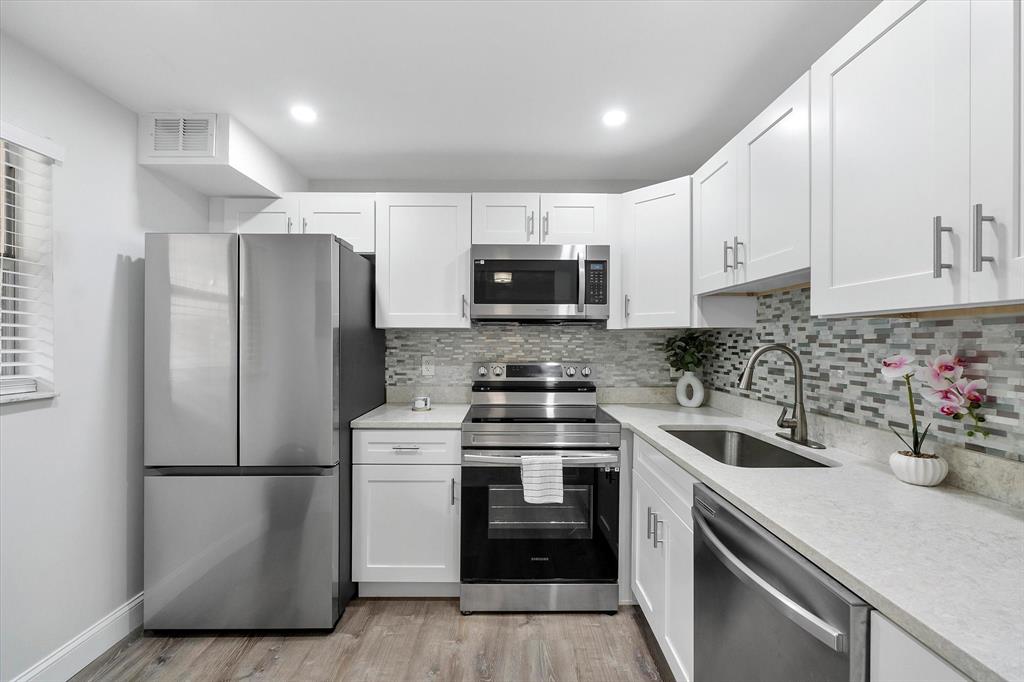 2840 Somerset Drive, Unit 205M Lauderdale Lakes, FL 33311 - Photo 11 of 22 a kitchen with a sink and steel stainless steel appliances