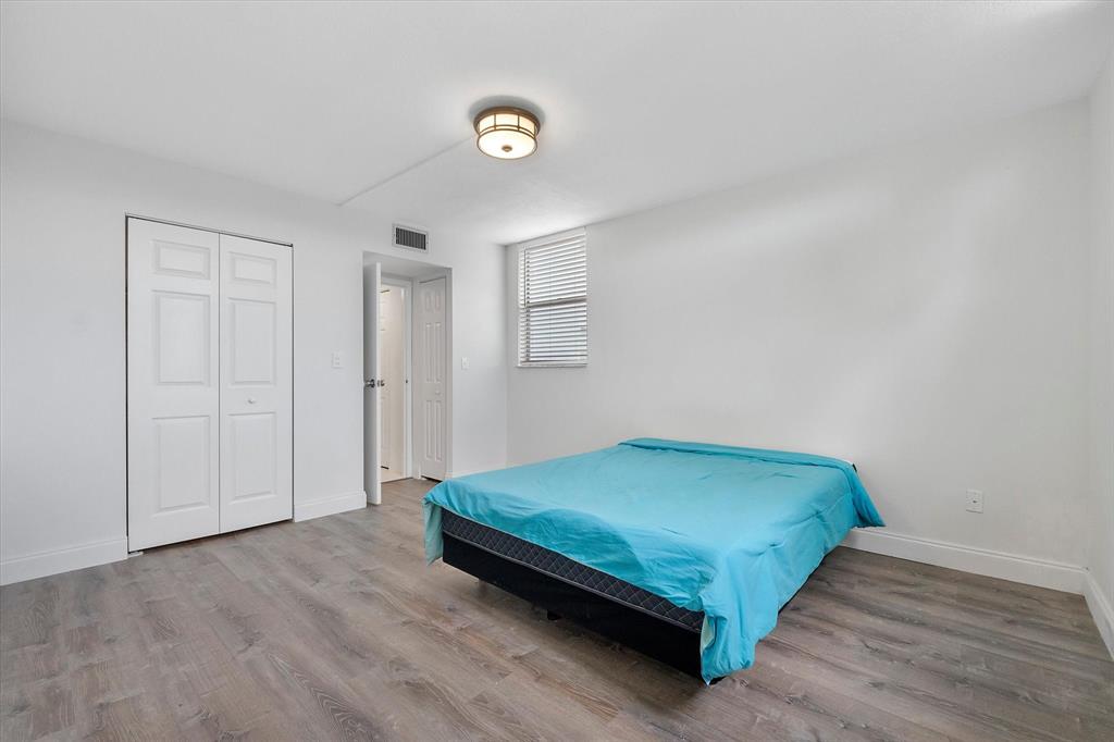 2840 Somerset Drive, Unit 205M Lauderdale Lakes, FL 33311 - Photo 14 of 22 a bedroom with a bed and a window