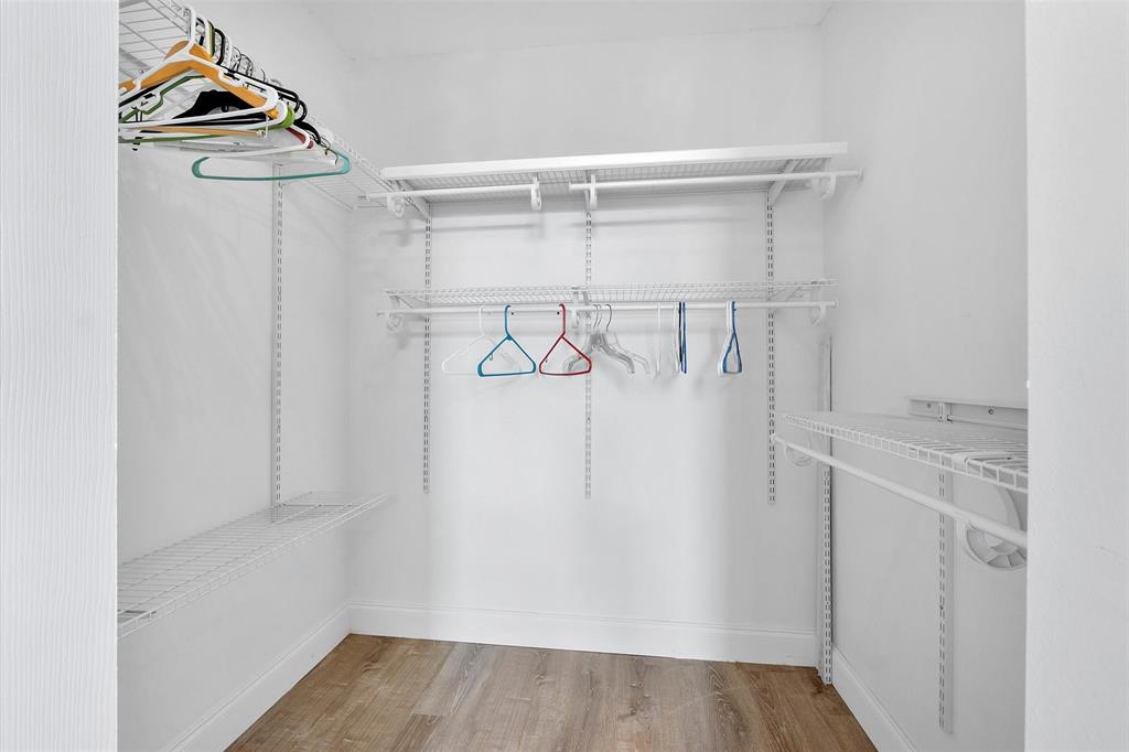 2840 Somerset Drive, Unit 205M Lauderdale Lakes, FL 33311 - Photo 15 of 22 a view of walk in closet with clothes and shoes