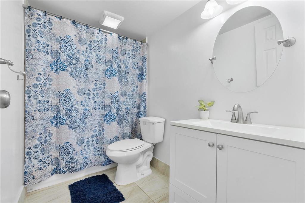 2840 Somerset Drive, Unit 205M Lauderdale Lakes, FL 33311 - Photo 16 of 22 a bathroom with a sink toilet and a mirror