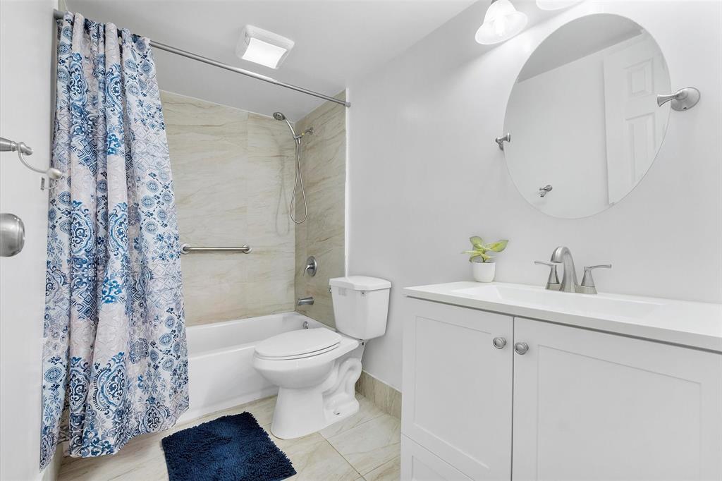 2840 Somerset Drive, Unit 205M Lauderdale Lakes, FL 33311 - Photo 17 of 22 a bathroom with a sink toilet and shower