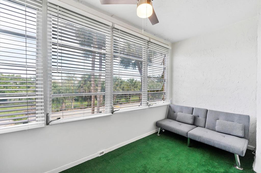 2840 Somerset Drive, Unit 205M Lauderdale Lakes, FL 33311 - Photo 19 of 22 a living room with furniture and a large window