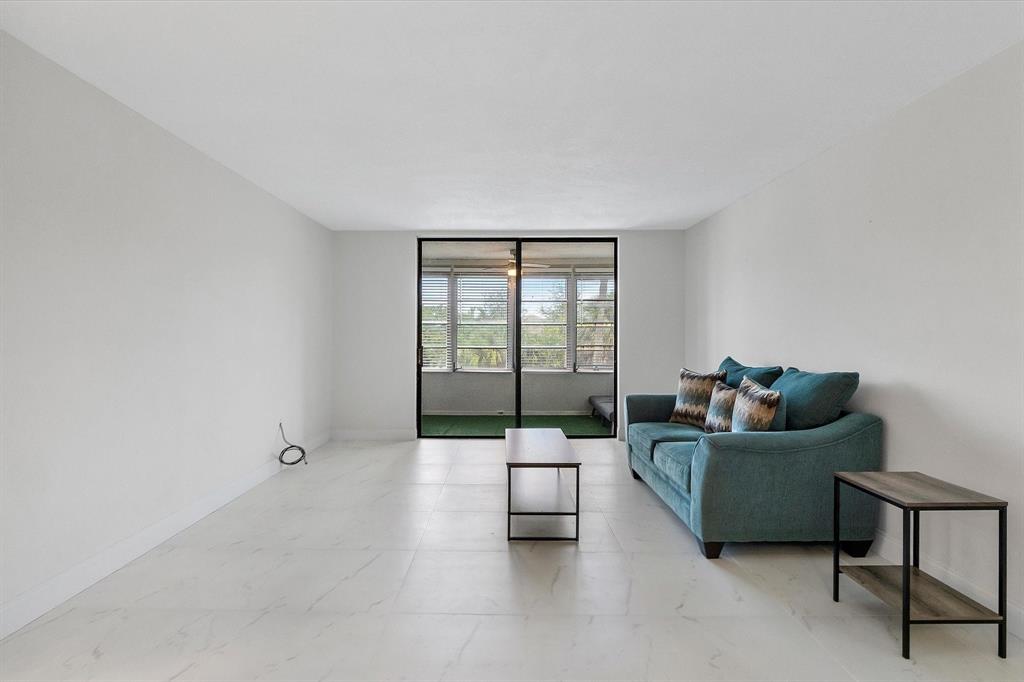 2840 Somerset Drive, Unit 205M Lauderdale Lakes, FL 33311 - Photo 6 of 22 a living room with furniture and a window