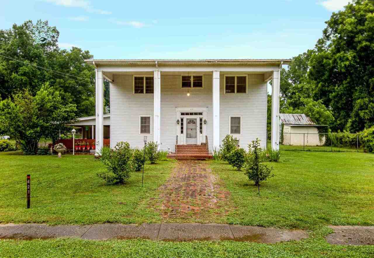 a front view of house with yard and green space