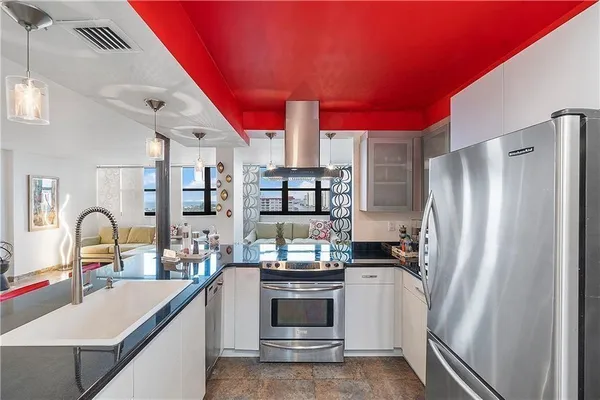 a kitchen with stainless steel appliances a refrigerator sink and cabinets