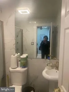 a bathroom with a shower and a toilet