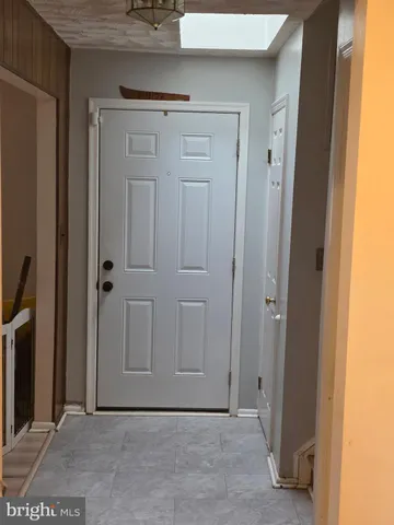 a kitchen with stainless steel appliances granite countertop a sink a stove and white cabinets