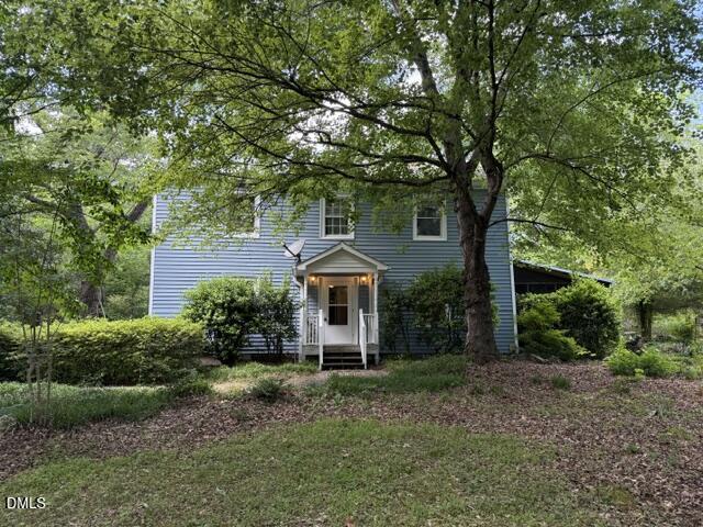 front view of a house with a tree