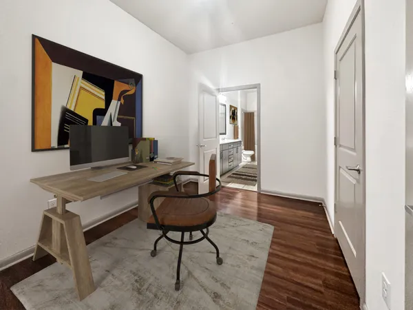 a living room with a table and a rug