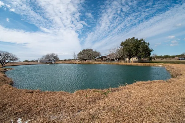 an aerial view of a houses with a lake
