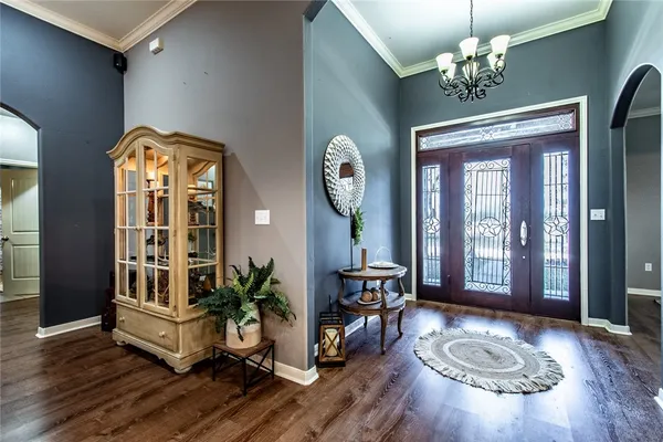 a view of hall way with furniture and wooden floor
