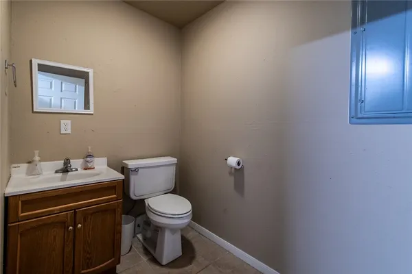 a white toilet sitting next to a bathroom sink