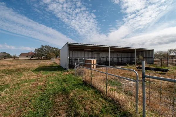 a view of house with backyard and seating area