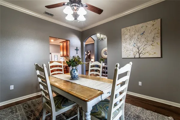 a dining room with furniture and chandelier