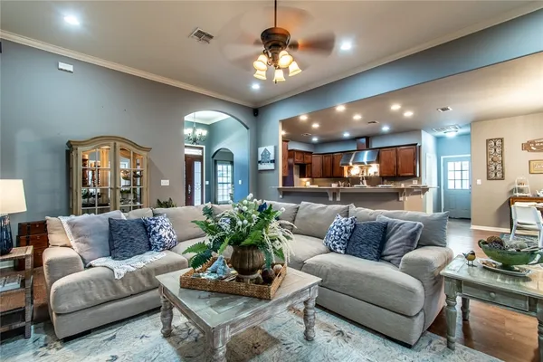 a living room with furniture or kitchen and a chandelier