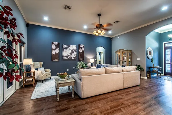 a living room with furniture and a chandelier