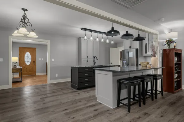 a kitchen with stainless steel appliances granite countertop a sink and cabinets