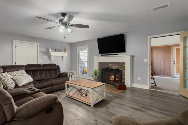 a living room with furniture and a fireplace