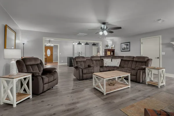 a living room with furniture and wooden floor