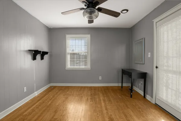 a bed sitting in a bedroom next to a window
