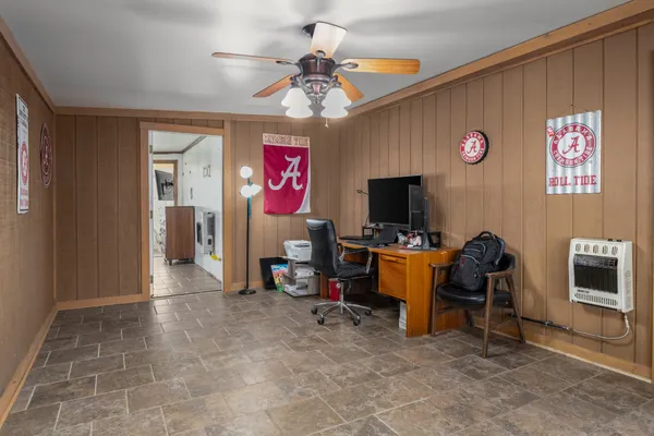 a view of a livingroom with workspace and a window
