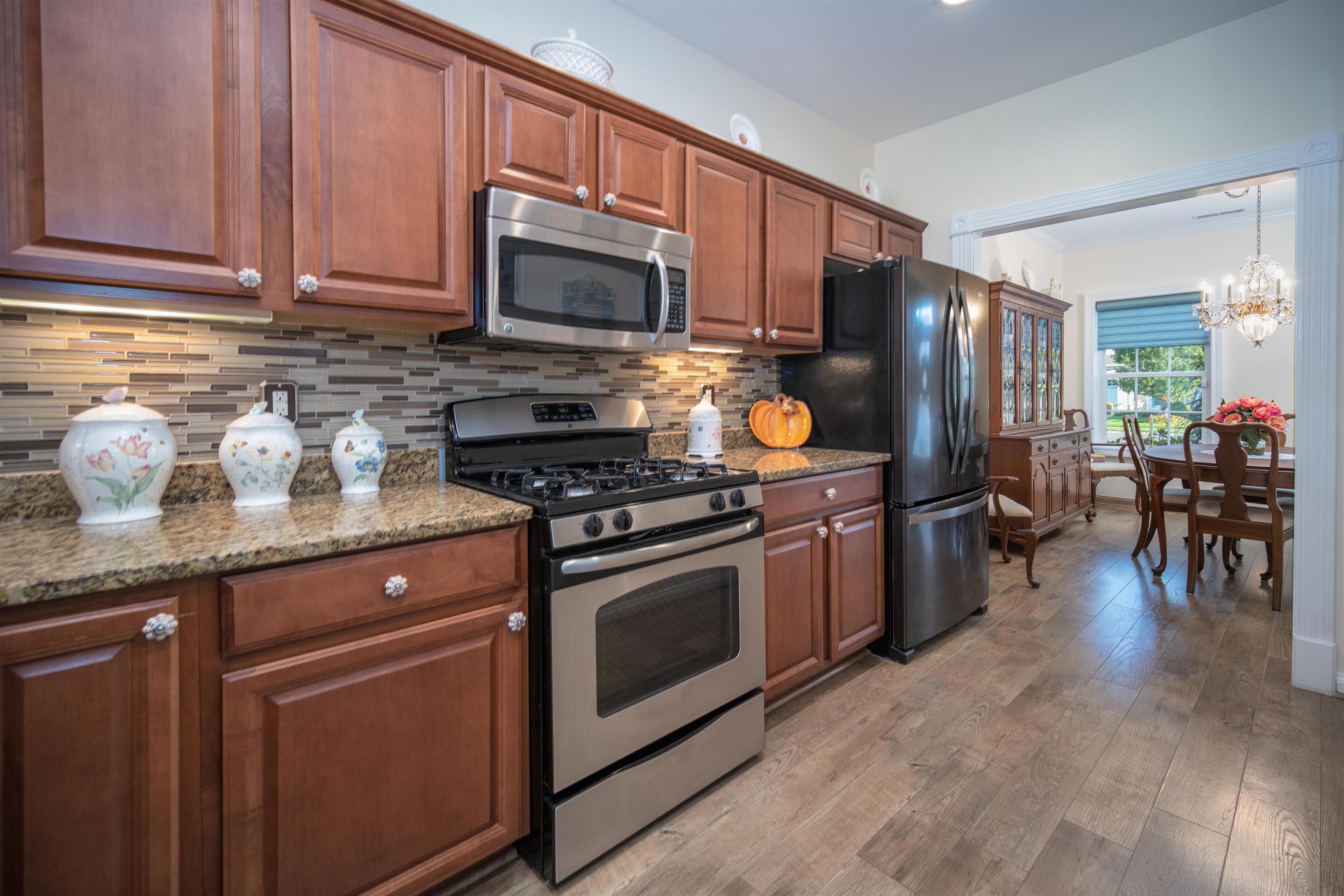 206 Seacrest Lane, Unit 155 Rio Grande, NJ 08242 - Photo 11 of 50 a kitchen with granite countertop wooden cabinets stainless steel appliances and a counter space
