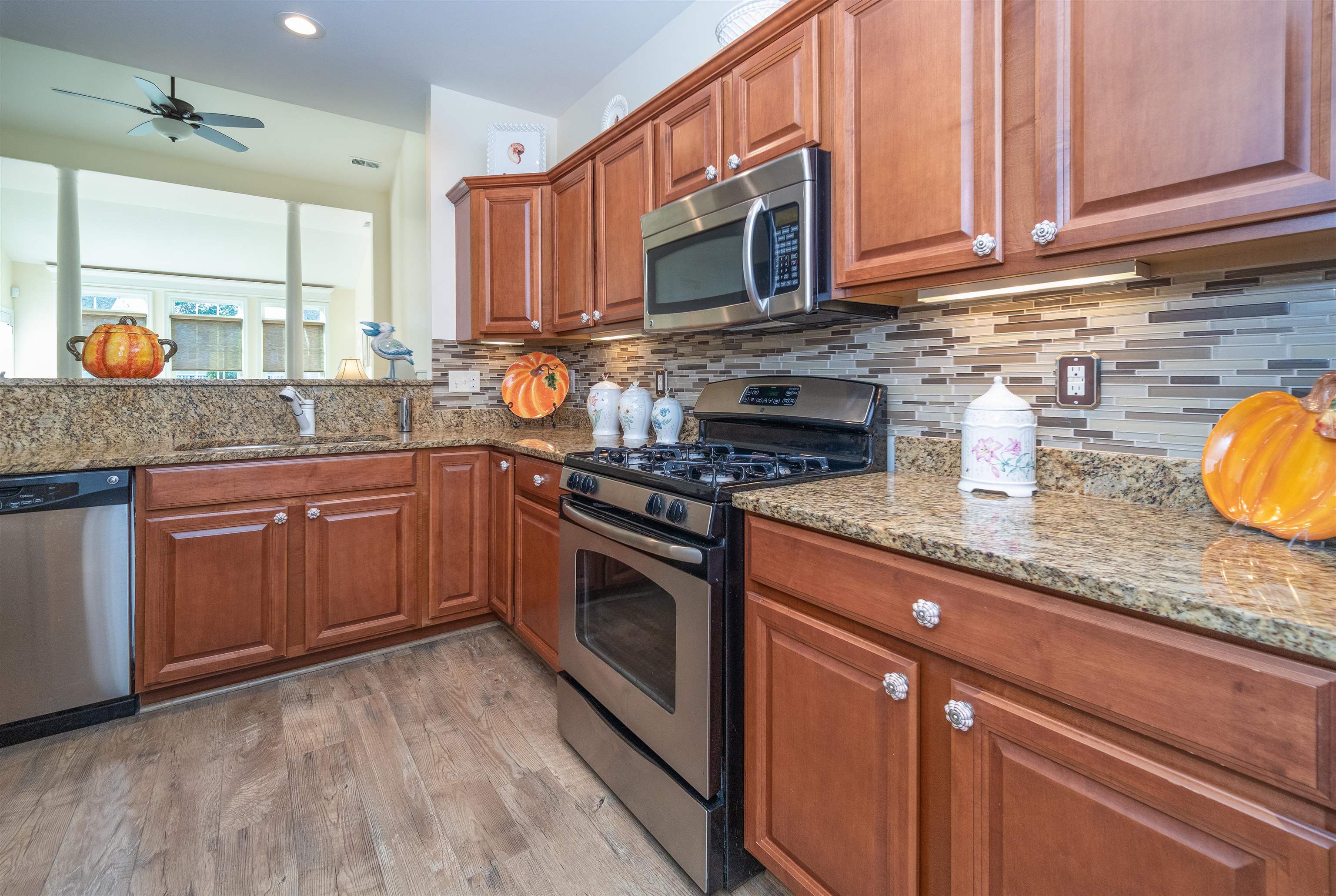 206 Seacrest Lane, Unit 155 Rio Grande, NJ 08242 - Photo 9 of 50 a kitchen with stainless steel appliances granite countertop a stove a sink and a microwave