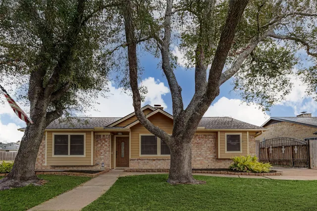 a kitchen with stainless steel appliances granite countertop white cabinets and window