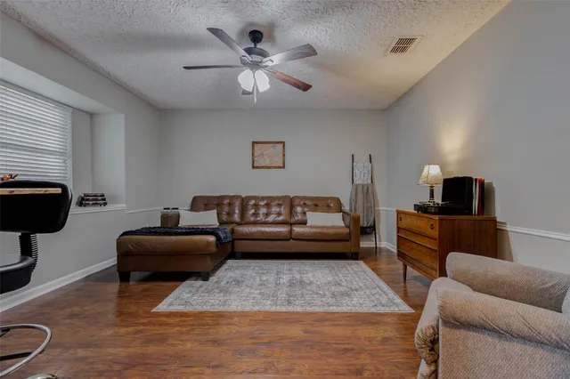 a bedroom with a bed and a ceiling fan