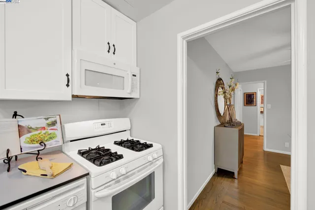 a kitchen with stainless steel appliances granite countertop a stove and a microwave