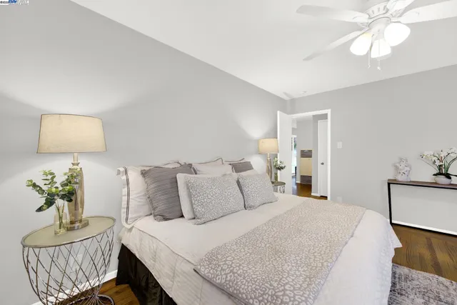 a bedroom with bed and wooden floor