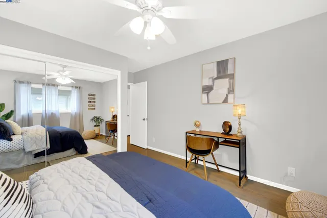 a bedroom with furniture and a mirror