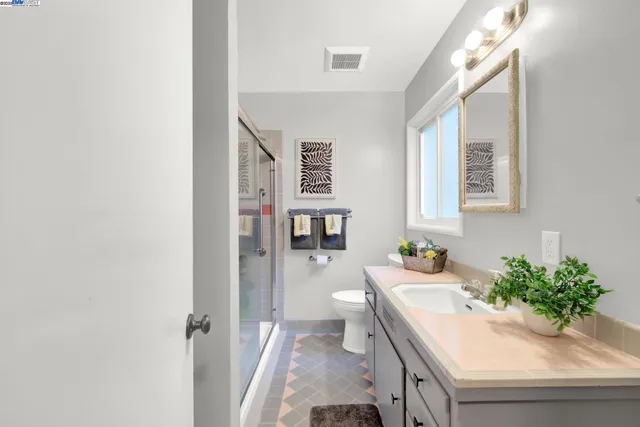 a bath room with a sink and a mirror