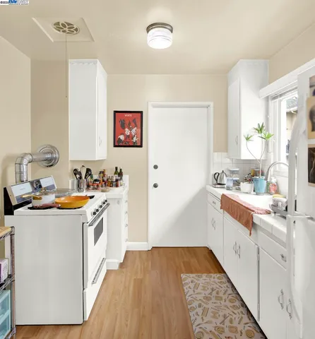 a kitchen with a stove a sink and a refrigerator