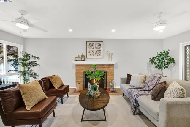 a living room with furniture and a fireplace