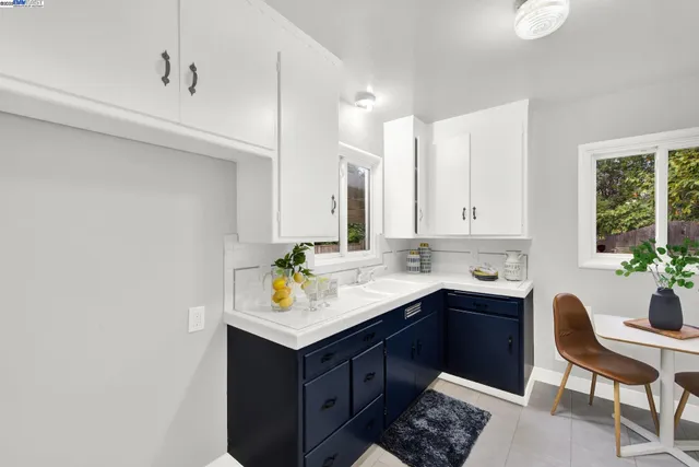 a kitchen with a sink cabinets and wooden floor