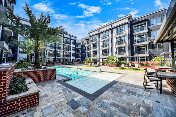 a living room with furniture and a painting on the wall