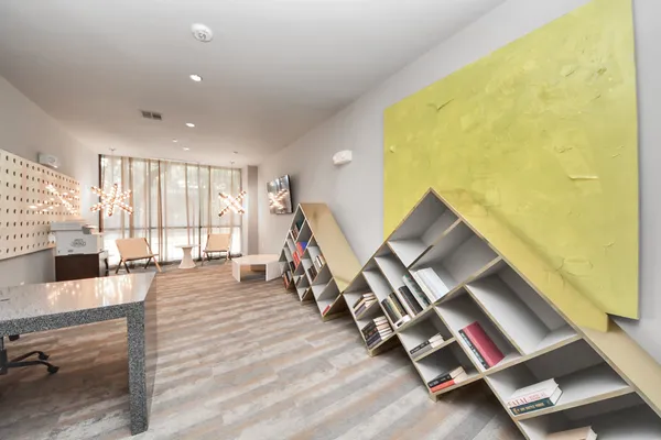 a bedroom with a bed a mirror and a large window