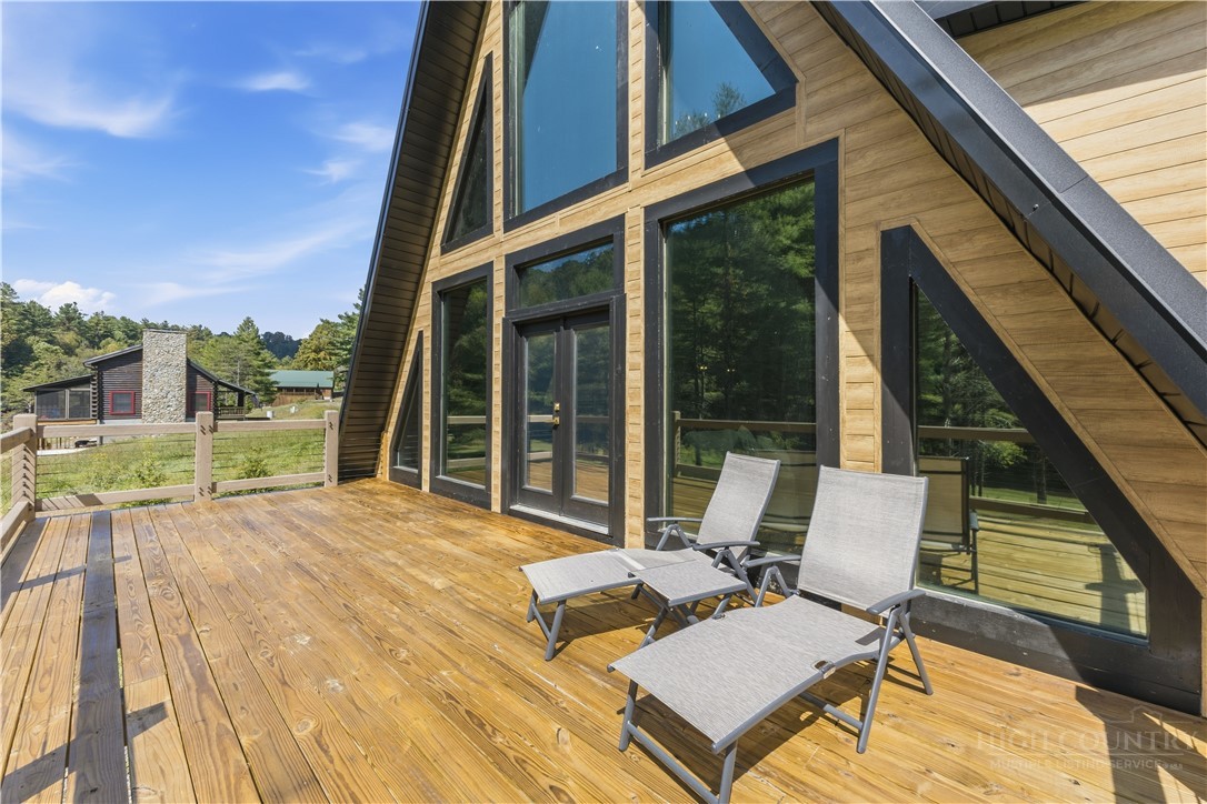 355 South River Hills Road Lansing, NC 28643 - Photo 42 of 45 a view of balcony with couch and wooden floor
