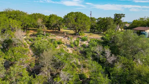an aerial view of residential houses with outdoor space and river