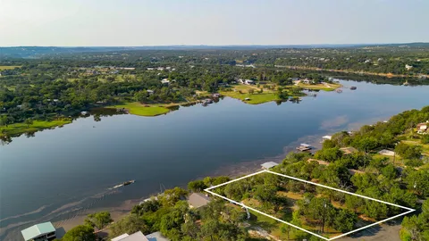 an aerial view of residential houses with outdoor space and river