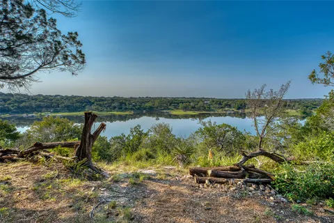 a view of a lake with table and chairs